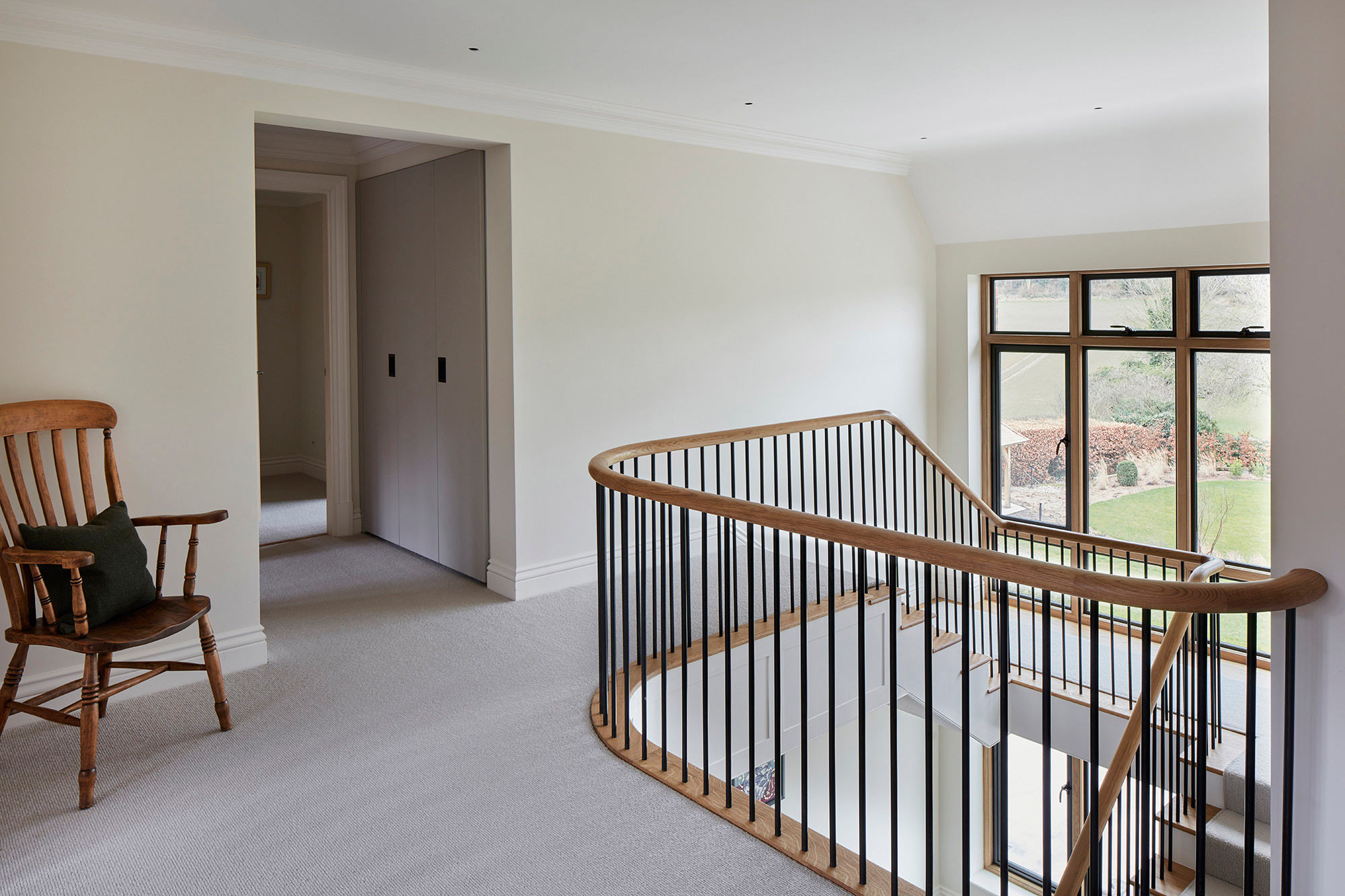 Landing with stair ballustrades and large window - New build by KM Grant Surrey